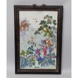 A Chinese enamelled porcelain plaque, decorated with immortals and pagodas in a landscape, framed,