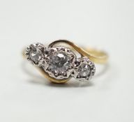 An 18ct and illusion set three stone diamond crossover ring, size I, gross weight 2.5 grams.