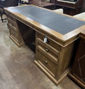 A contemporary reclaimed wood kneehole desk, width 174cm, depth 79cm, height 82cm