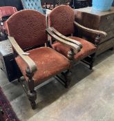 A pair of 1920's Jacobean revival oak elbow chairs, width 60cm, depth 65cm, height 103cm