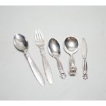 Five assorted items of Georg Jensen flatware including christening fork and spoon, caddy spoon,