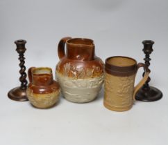 A group of three salt-glazed stoneware vessels and a pair of walnut barley-twist candlesticks, the