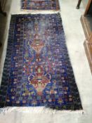 A Caucasian blue ground carpet, approx. 290 x 162cm together with a near pair of smaller North