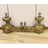 A French gilt bronze pair of urn shaped chenet, 39cm wide