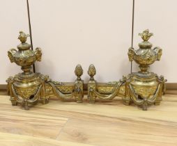 A French gilt bronze pair of urn shaped chenet, 39cm wide