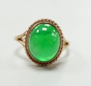 A 9ct gold and cabochon jade set oval ring (shank cut), gross weight 4.3 grams.