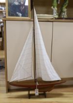 A painted wood pond yacht with fabric sails on stand, 97cm high