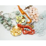 A quantity of assorted costume jewellery, necklaces, simulated amber, paste pendant, silver ingot