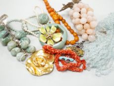 A quantity of assorted costume jewellery, necklaces, simulated amber, paste pendant, silver ingot