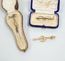 An Edwardian enamel and diamond set 'horse and jockey' stick pin, 63mm, a yellow metal and seed
