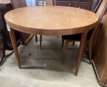 A mid century circular teak extending dining table, length 130cm extended, two spare leaves, depth