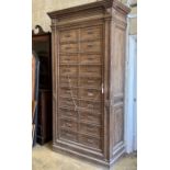 An early 20th century French oak notaries cabinet with 20 fall front compartments, width 125cm,