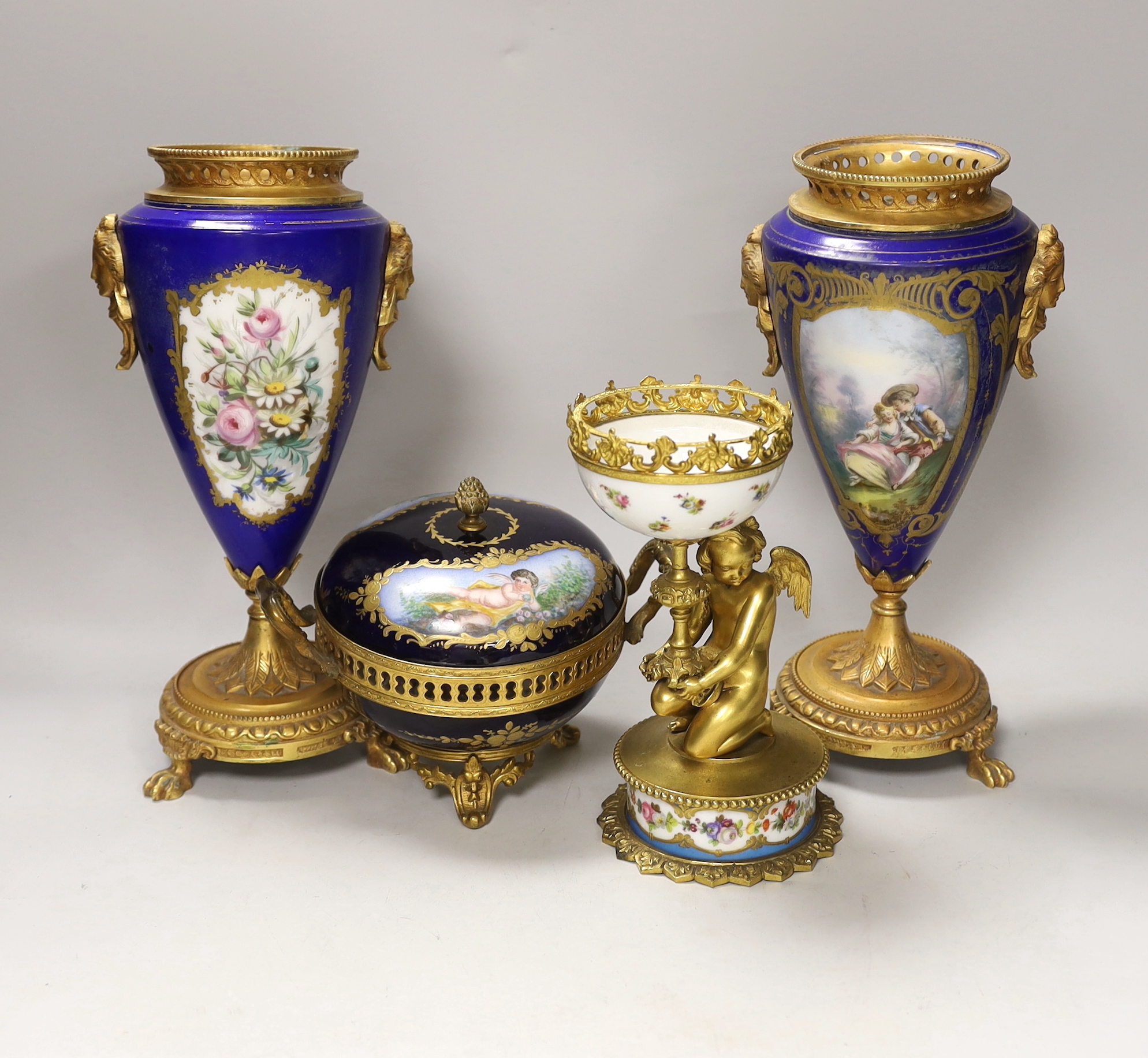 A pair of Sevres style porcelain ormolu mounted vases, a similar putti stemmed cup and a bowl and