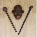 A tribal mask, a Knobkerrie and stick with carved head, stick 62.5cm