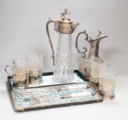 Two claret jugs, one with gilt decoration, four silver plated cup holders with glass liners and
