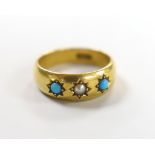 An early 20th century 18ct and gypsy set turquoise and seed pearl three stone child's ring, size