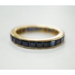 A yellow metal and sapphire set full eternity ring, size R, gross weight 4.6 grams.