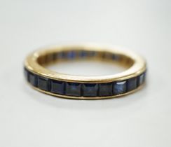 A yellow metal and sapphire set full eternity ring, size R, gross weight 4.6 grams.