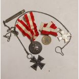 Four German medals including an iron cross, a Hamburg Kreuz 1914 with ‘Fur Verdienft im Kriege 1914’