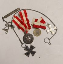 Four German medals including an iron cross, a Hamburg Kreuz 1914 with ‘Fur Verdienft im Kriege 1914’