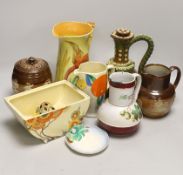 Four Clarice Cliff items; a miniature dish, jug, etc. together with four jugs and a biscuit