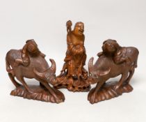 Three Chinese carved hardwood figures, tallest 23cm