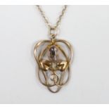 An Edwardian Art Nouveau 9ct and gem set pendant, on a 9ct chain, overall 52cm, gross weight 3.1