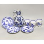 A late 17th century Delft blue and white ewer and three Chinese style tumblers and saucers,