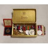 Three WWII medal groups and a German medal etc., a boxed WWII pair (addressed to Mrs Howard-