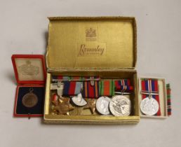 Three WWII medal groups and a German medal etc., a boxed WWII pair (addressed to Mrs Howard-