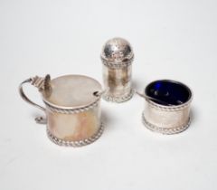 A George V three piece silver condiment set, Stokes & Ireland, Chester, 1923 and two associated