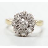 A yellow metal and nine stone diamond set cluster ring, size N, gross weight 5 grams, chip to centre