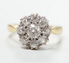 A yellow metal and nine stone diamond set cluster ring, size N, gross weight 5 grams, chip to centre