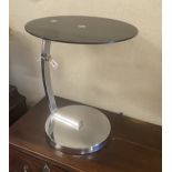 A chrome and black glass circular occasional table, diameter 45cm, height 54cm