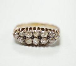 An 18ct and two row diamond cluster set half hoop ring, size R, gross weight 4.6 grams.
