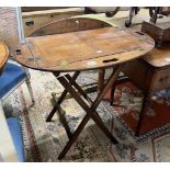 A Victorian brass mounted oval mahogany folding butler's tray / table on stand, width 90cm, height