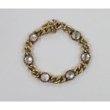 An Edwardian 15ct gold and six stone cabochon moonstone set child's curb link bracelet, 12cm,