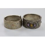 A late Victorian silver and three stone amethyst and citrine set hinged bangle and a later white