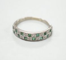 A modern 18ct white gold and two row emerald and diamond cluster set half hoop ring, size S, gross
