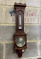 A Victorian walnut cased aesthetic movement style aneroid barometer and thermometer, Negretti &