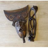 An African carved wood mask and a similar sculpture, 61cm high