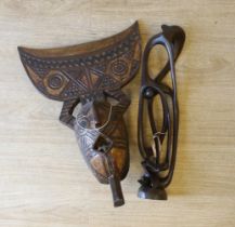 An African carved wood mask and a similar sculpture, 61cm high