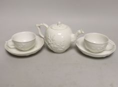A 18th century Meissen teapot and two teacups and saucers, c.1740