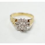 A modern 18ct gold and diamond chip set flower head cluster ring, size P, gross 4.5 grams.