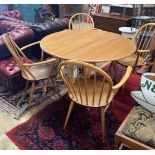 An Ercol oval elm drop leaf dining table, length 123cm extended, width 113cm, height 71cm and four