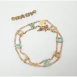 An Edwardian 15ct?, turquoise and seed pearl set 'Good Luck' chain bracelet, 17cm and a yellow metal