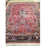 A Tabriz red ground carpet, 345cm x 241cm