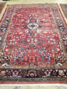 A Tabriz red ground carpet, 345cm x 241cm