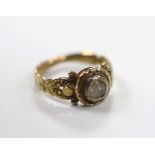 An early 19th century yellow metal and collet set rose cut diamond ring, with carved shoulders, size