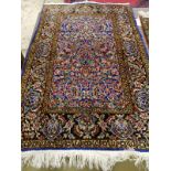 A North West Persian part silk blue ground rug, 89cm x 58cm